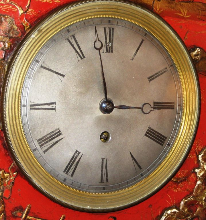 A French Empire Period hanging wall clock with a painted and parcel-gilt wooden case, decorated with Chinoiserie lacquer.  The clock mechanism is marked 