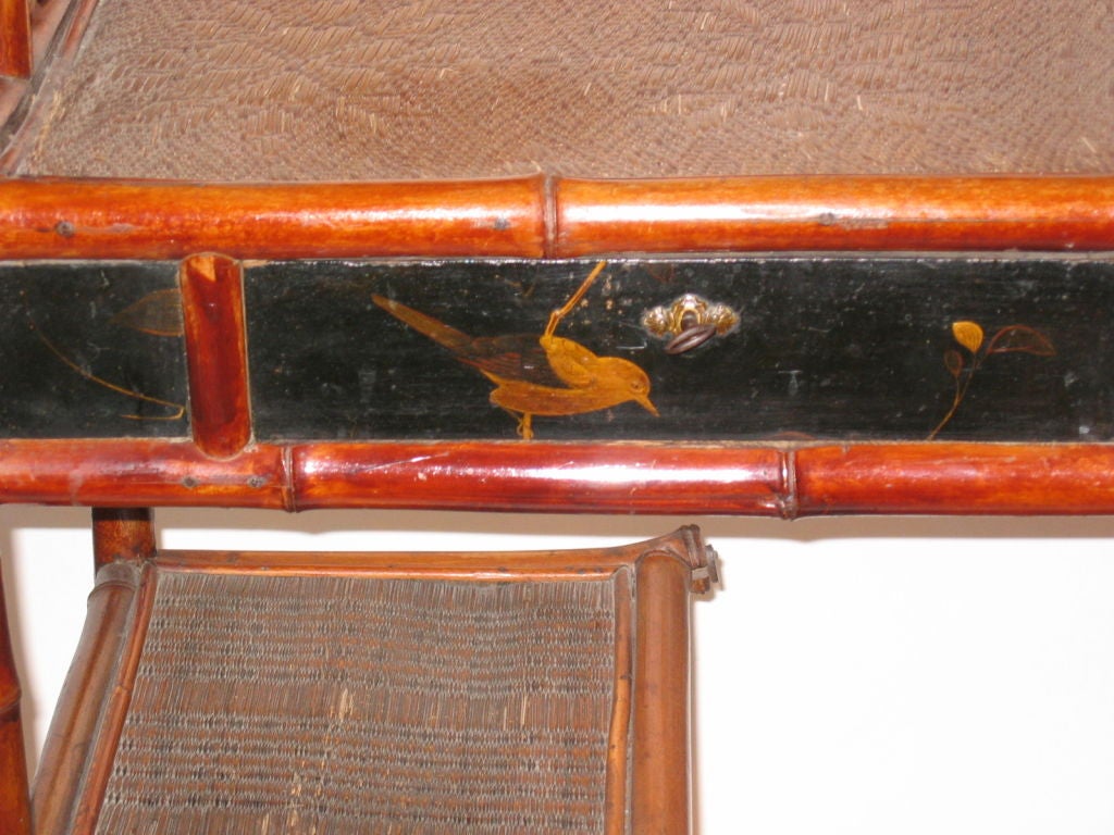 A Japanese bamboo and lacquer etagere, 19th century, the drawer painted with leaves and a bird.