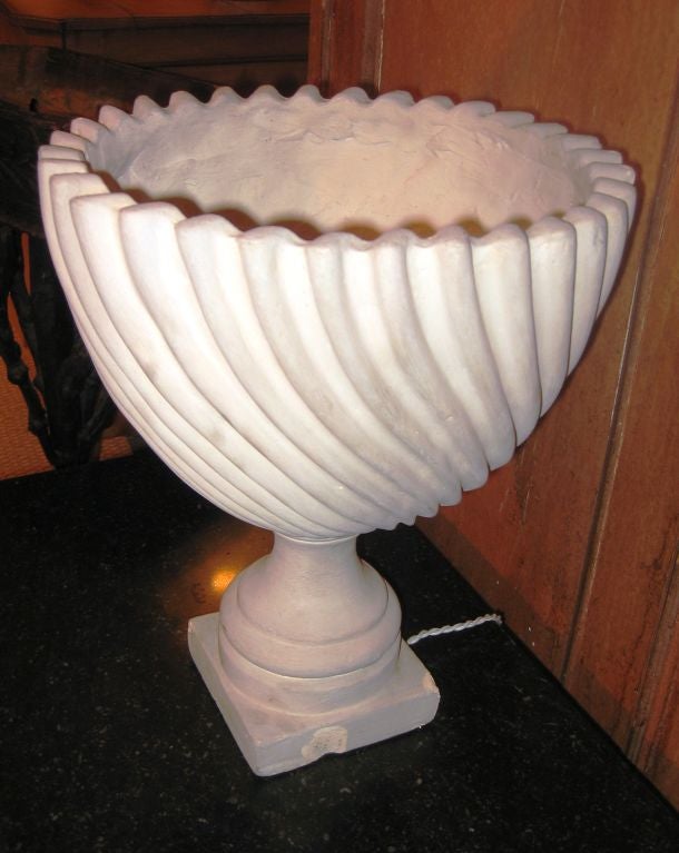 A decorative French 30's urn-form table lamp in cast plaster, with twisted fluting on the bowl, rewired.