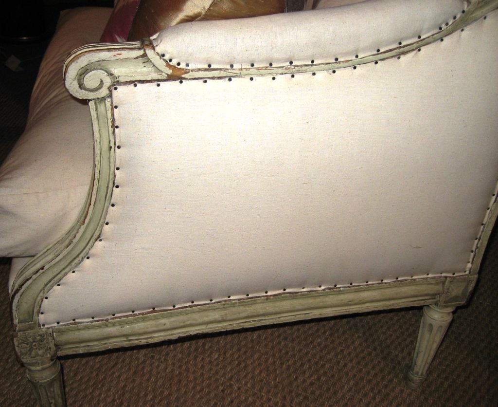A fine French Louis XVI period Marquise, circa 1790,  retaining its original grey/white painted finish, recently re-upholstered in white muslin.