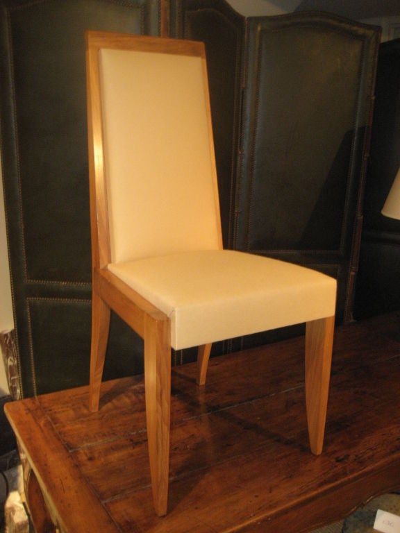 A chic set of six French dining chairs in walnut with upholstered seats and backs, 1940s.