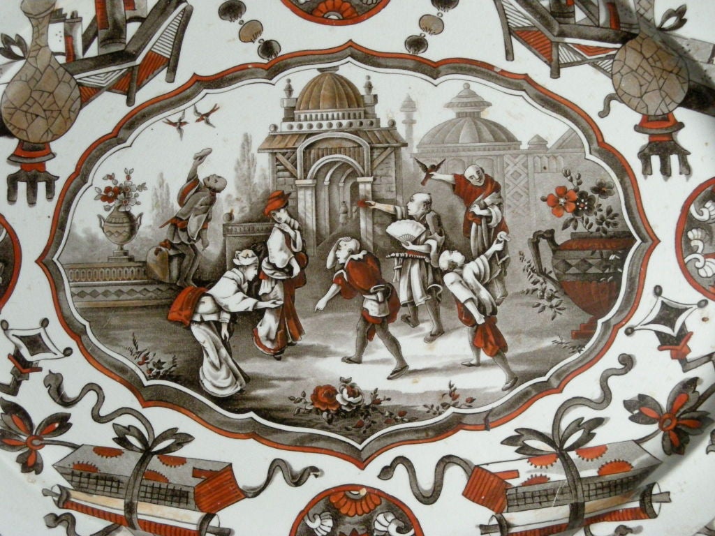19th century English white ironstone Staffordshire oval platter with whimsical transfer printed chinoiserie decoration in the 'Yeddo' pattern, in black and charcoal, with hand painted highlights in  terra cotta red, grey, taupe and gold. Signed with