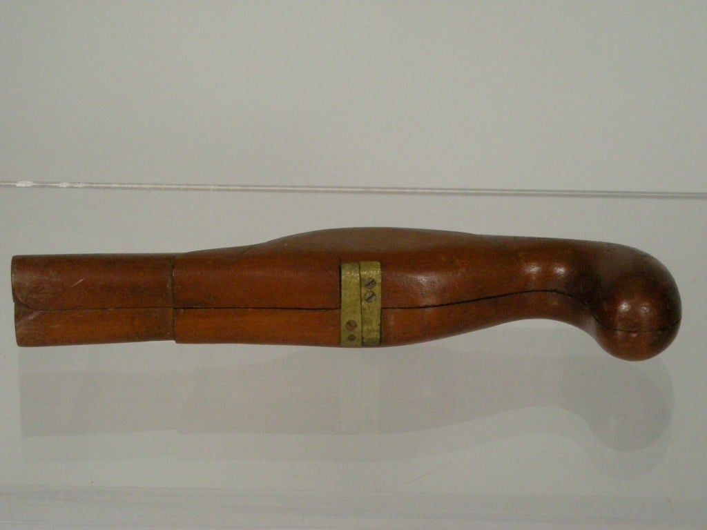 Solid wood (mahogany?)  double barreled pistol form boot jack in mahogany, in two half sections joined by brass hinges.