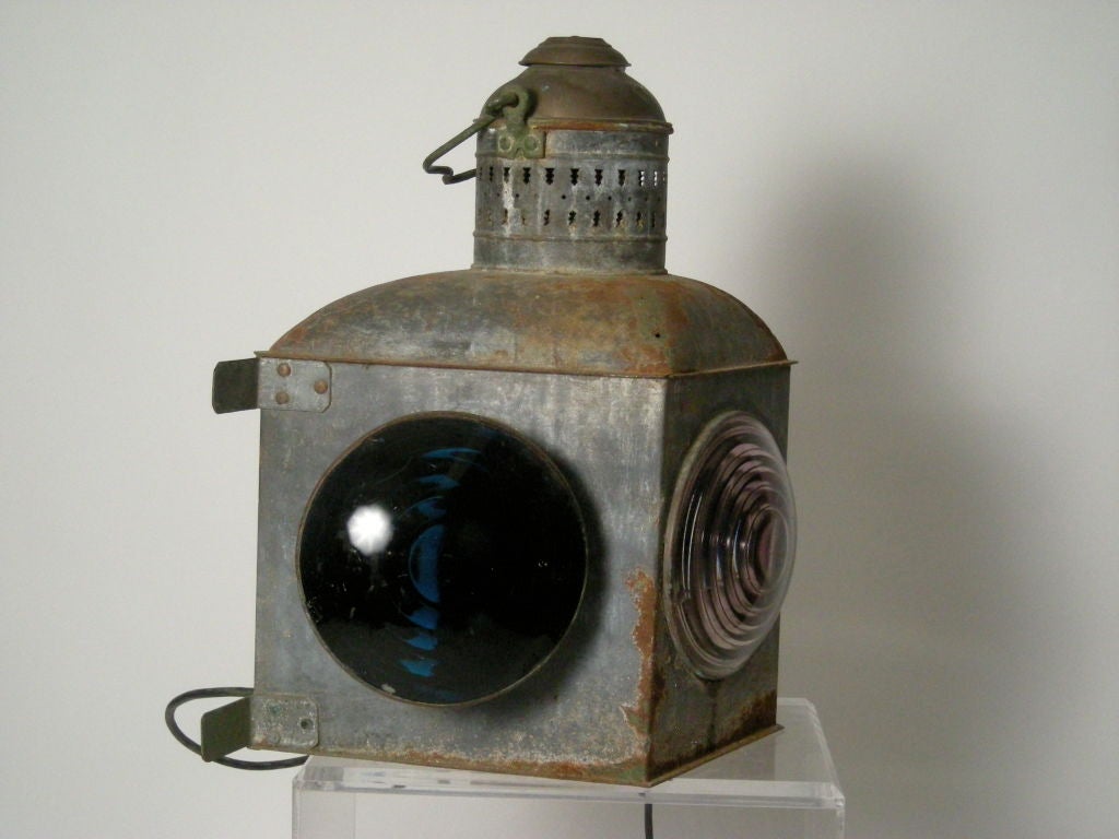 Large, graphic ship or railroad light in steel with 3 large round, ribbed glass lenses in clear (pale violet from age), red (port) and blue (starboard).<br />
Great form and scale. Newly re-wired.