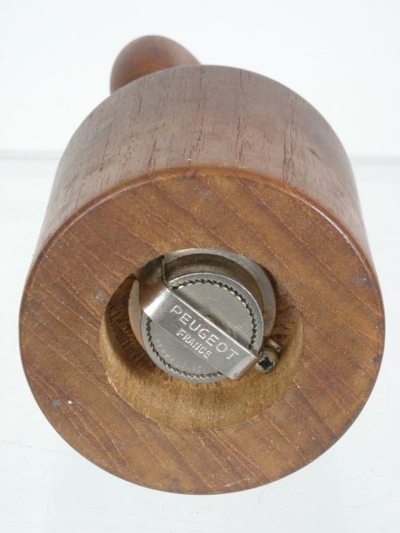 Sculptural, Scandinavian modern pepper mill in teak, with revolving ring form handler, and premium steel Peugeot grinder. Great form, works very well.