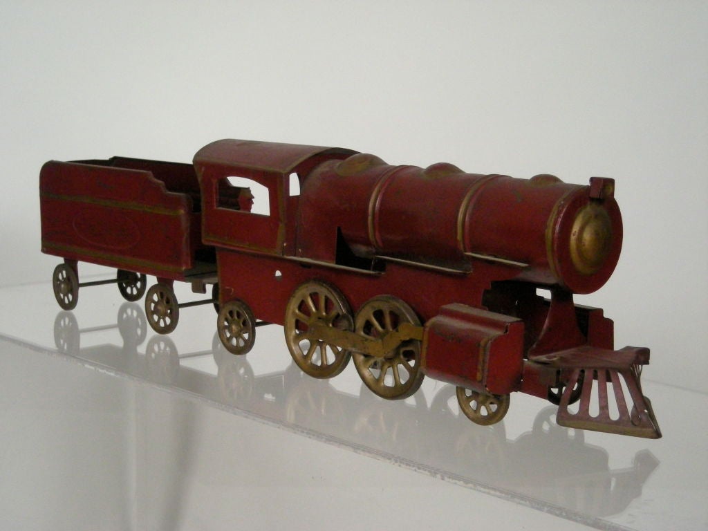 Antique Dayton Company friction toy hill climber/coal locomotive with detachable coal car, in all original red paint,with gold trim. Provenance: A private New England collection.
