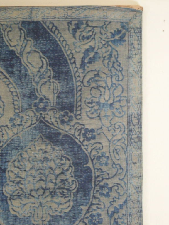 Large antique Fortuny fabric panel with overall indigo blue floral and foliate design, in 2 sections sewn together, with a border around the 4 edges. Backed with silk.<br />
Blue is richer than photographs suggest. Last photo shows color more