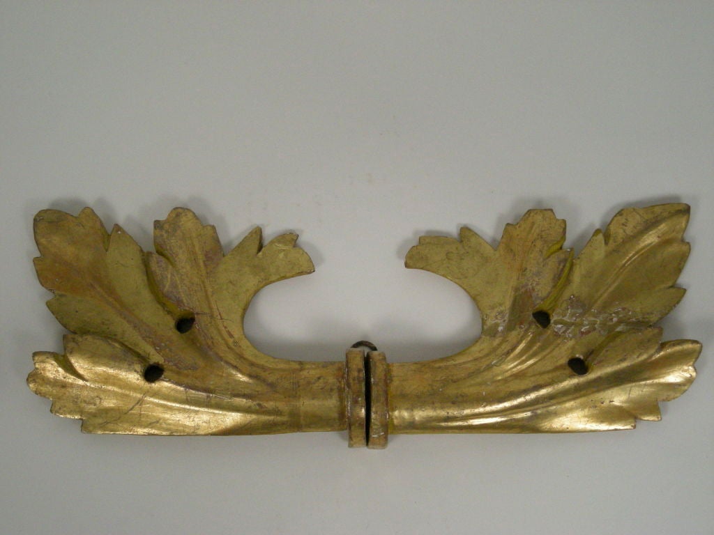 Pair of 19th century Continental carved giltwood acanthus leaf decorations, originally made as curtain rod ends (the two ends of the curtain rod have been combined to make each). Beautiful as wall or over-door decoration.