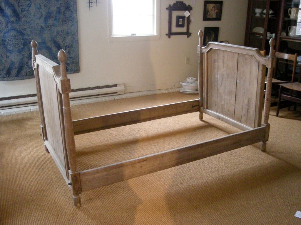 Solid, carved chestnut 19th century Louis XVI style daybed. The head and footboard are the same size and may be used without the rails as 2 twin bed headboards.<br />
Good, soft, worn color and texture.
