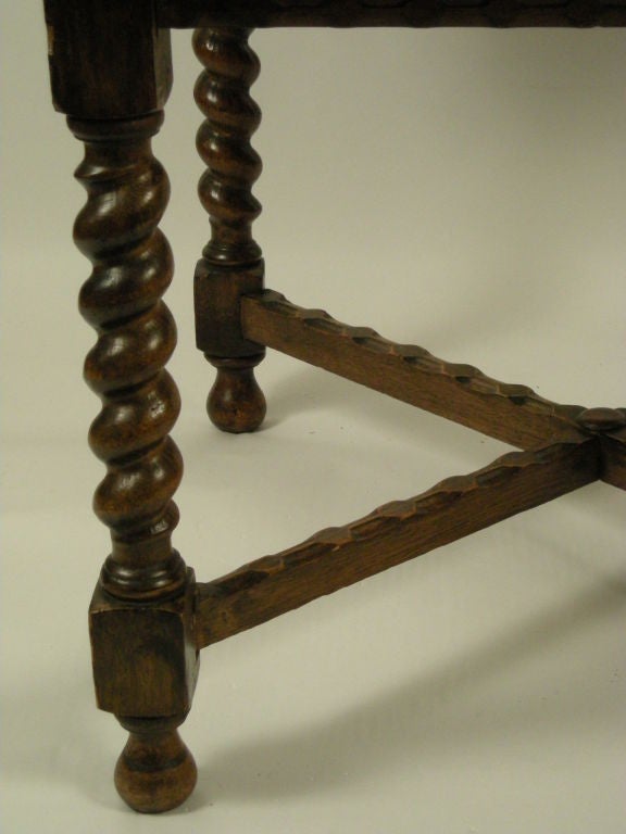 William and Mary style oak extension table with barley twist legs and carved x-form stretcher.