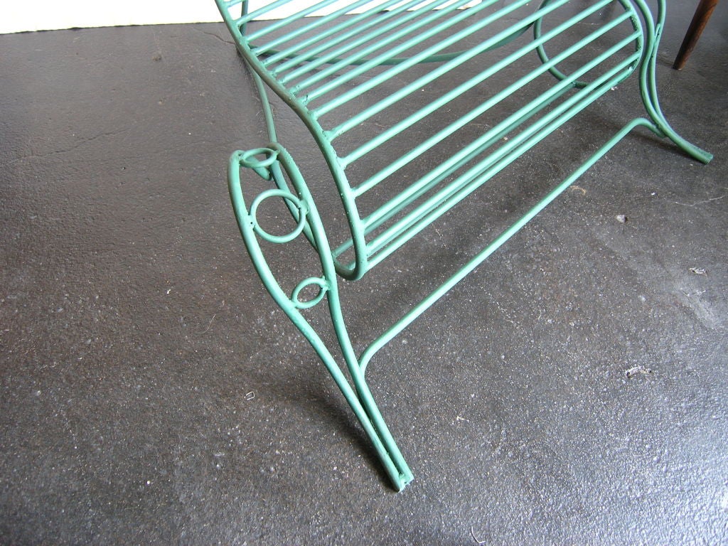 This lyrical wrought iron chair was custom-made in the style of André Dubreuil's Spine chair and purchased in Paris in the 1990s. It features a verdigris finish and would work well both indoors and out.