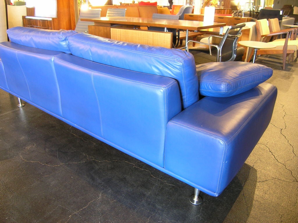 Beautiful in style and quality-made Italian leather sofa. Wide comfortable armrests are sturdy enough to sit on, and the sofa comes with two matching throw pillows.