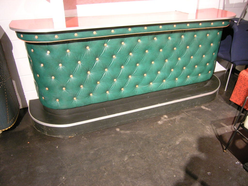 This is a great example of a funky 1950s bar set. The tufted vinyl front is the original green with contrasting pink details and the formica countertop is a luscious red. The interior depth of 16