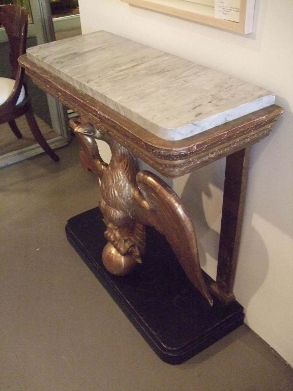 A wonderful carved giltwood eagle console table with marble top retaining it's original surface.