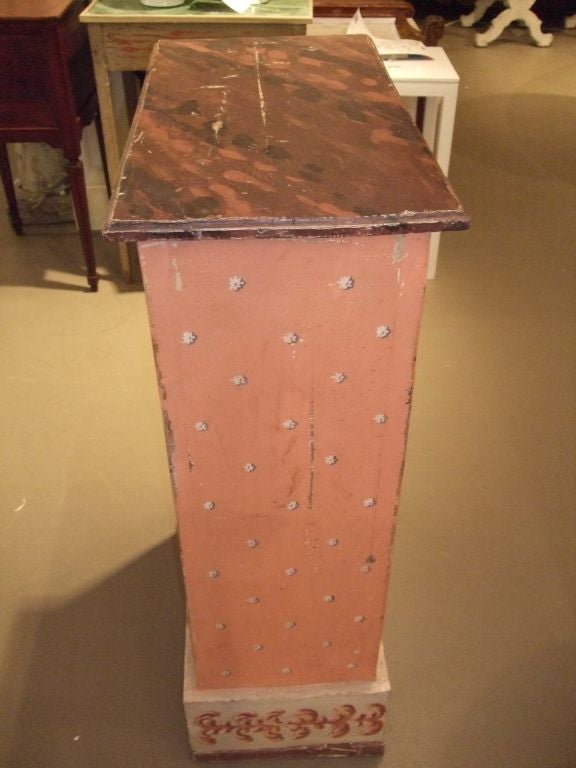 Hand-painted pedestal with marbleized top, rosettes and decorative base.
