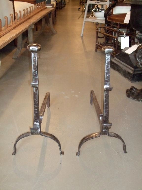 Pair of 18th century andirons with hooks, round tops and incised decoration.