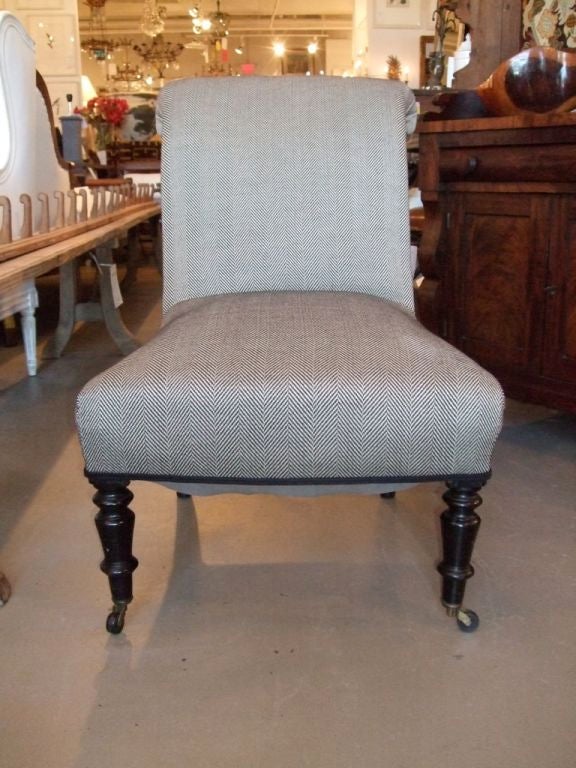 Napoleon III slipper chair with ebonized turned legs newly upholstered in a herringbone black and white fabric.