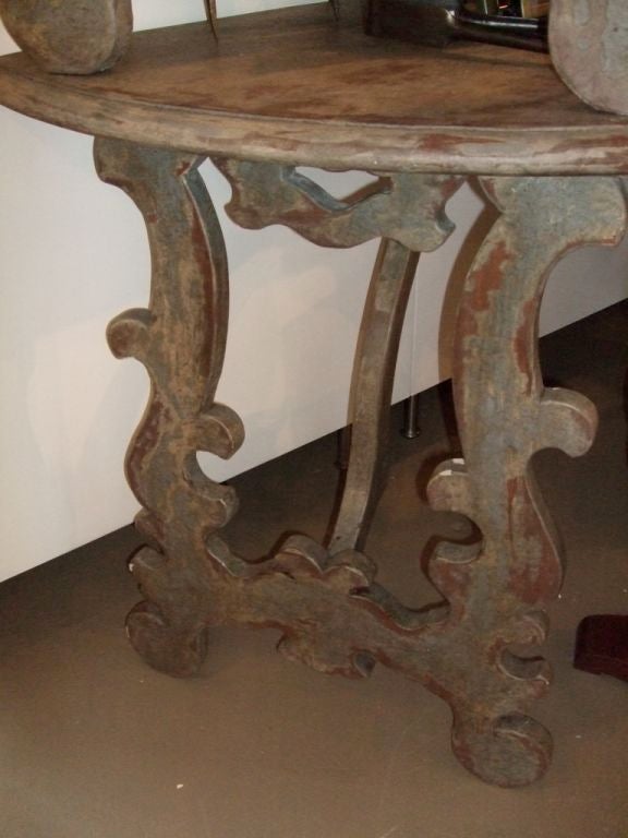 Painted Rococo style demilune, antique grey distressed finish. Highlights of red-brown, ochre and gray. Ogee edge at top.
