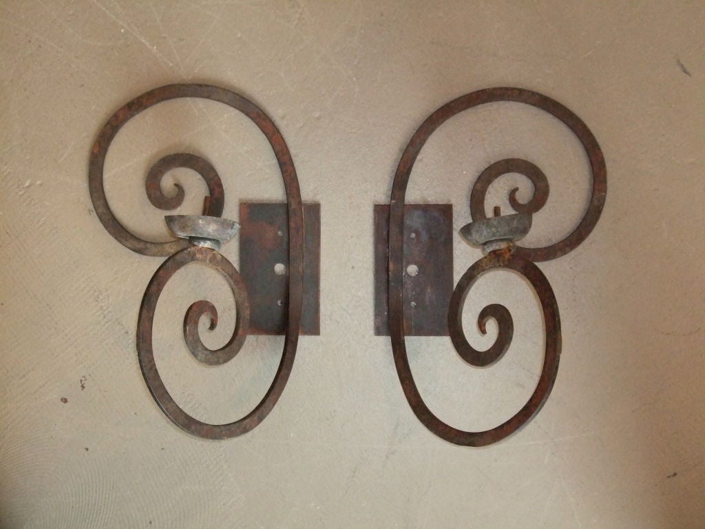 Scrolled single arm wrought iron sconce. Sold individually.