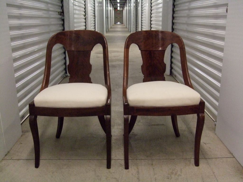 Pair of spoon backed Mahogany Empire chairs with carved back splats reupholstered in muslin.