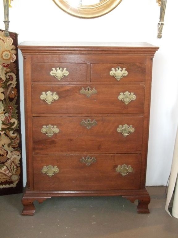 18th century Chippendale chest of drawers with bracketed feet and original brass hardware.