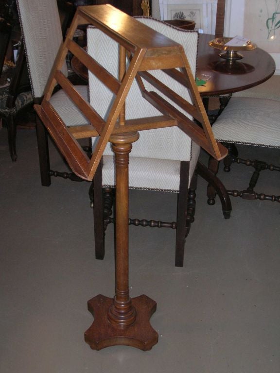 Two-sided walnut book/music stand with turned base and rotating top. Great for a library.