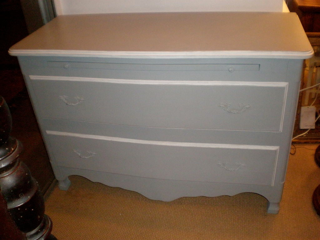 Contemporary gray and white painted two-drawer dresser with carved apron and slide. Made in France.