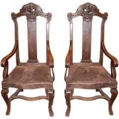 Pair of carved high back arm chairs