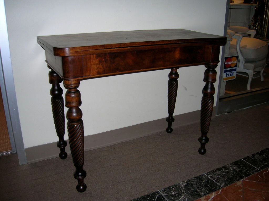 Mahogany card table with unusual rope turned legs and a flip top.