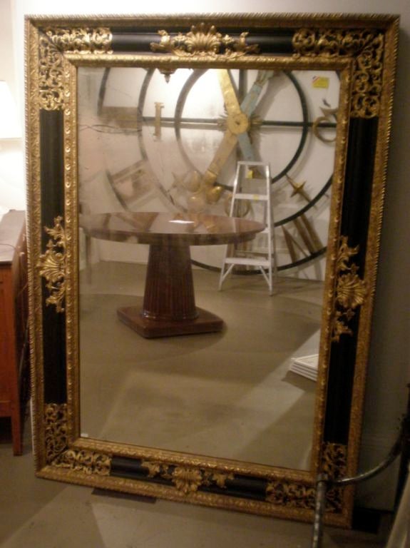 Large, 19th century Dutch ebonized mirror with gilded brass mounts.