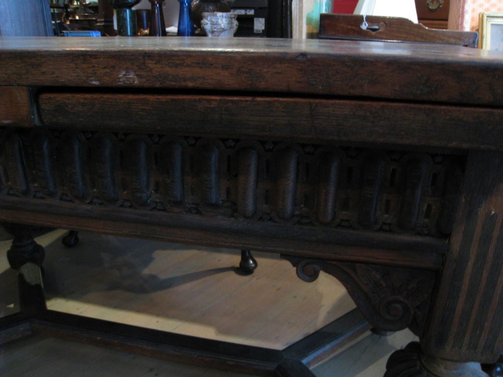 Rectangular panelled top over a gadrooned base, with carved spandrels, ebonized inlaid legs with melon and carved turning. X-form stretcher, ball feet. (Extended Width is 98.5