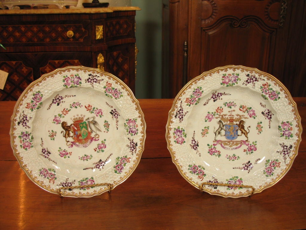 Set of eight porcelain armorial plates by Samson with various family crests.   Three plates bear a crest with a lion and horse.  Three plates bear a crest with a panther and lion and the motto 