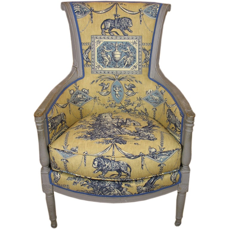 French Directoire period blue-gray painted bergere, newly-upholstered in lovely blue and gold toile fabric based on a museum-archived pattern. Very pure neoclassical detailing and form.