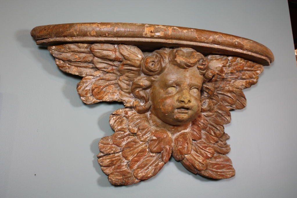 French carved wood cherub with wings, with console shelf top.  Beautifully sculpted features and feather detailing on wings.