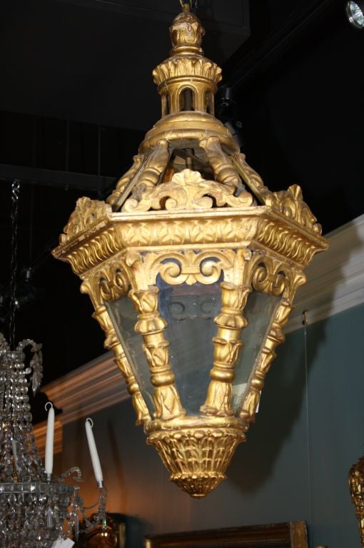 Wonderful hexagonal-form carved and gilded wood Venetian lantern.  The lantern has been wired with one light.  Nice carved details and patina. Losses to two of the cartouches over the cornice.