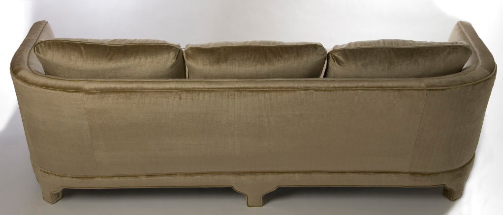 + An impressive sofa with great lines<br />
+ The profile is comprised of a curved back and fanciful yet solid fretwork legs<br />
+ The front and the back each have a series of three upholstered legs<br />
+ Three loose back cushions rest on top