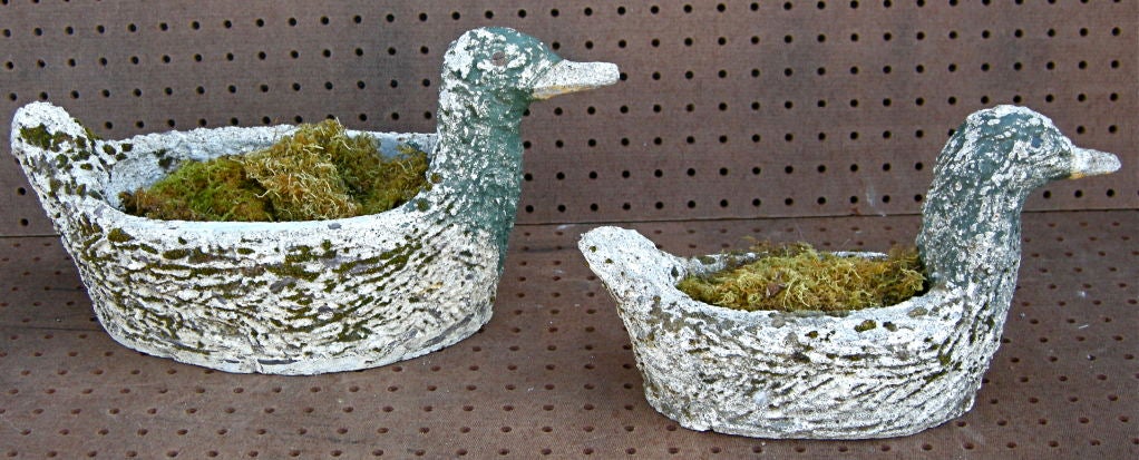Charming pair of naive, vintage hand formed planters in duck motifs.  A mother duck and her offspring, worn and weathered over many garden years.  Traces of original paint with found nails and screws for eyes embellish their simple aesthetic and add