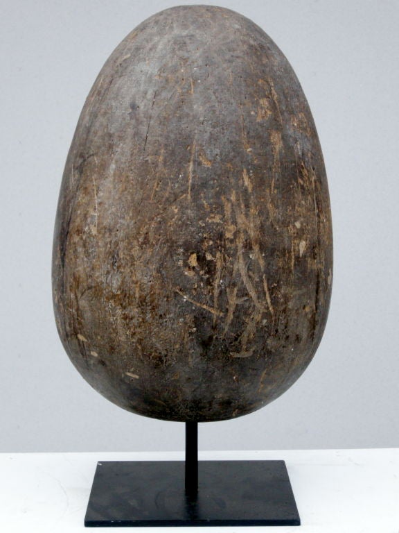 Hand carved, solid wood egg.  Used as a mold to make paper eggs that were later sold to novelty and retail stores of the period.