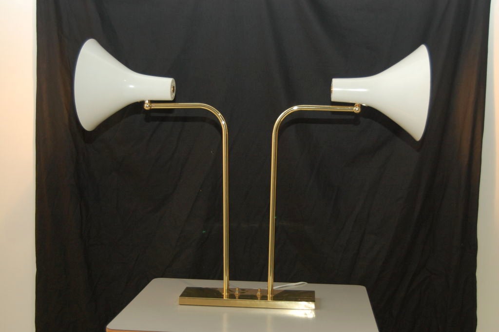 Title: VON NESSEN DOUBLE HEADED DESK LAMP<br />
Country: U.S.A<br />
Period: 1960's<br />
<br />
Walter Von Nessen Studio , U.S.A , 1960's dual desk lamp , white metal shades on brass arms and base , heads are multi positional and arms rotate ,