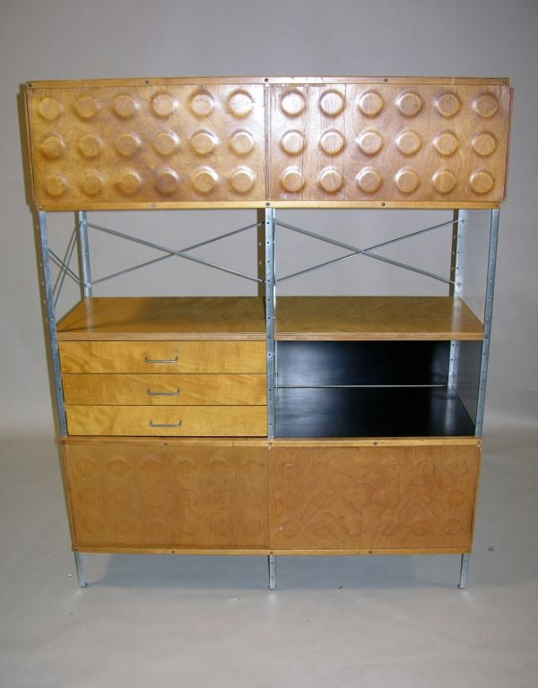 This Eames Storage Unit (ESU) , model no. 420 - N , dates from the first two years of production, featuring a monochromatic color scheme and dimple doors.