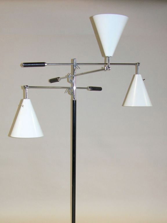 This playful and sculptural lamp is an Icon of 20th century design.  This example features white cones with chrome rods and black stem.<br />
Signed with impressed mark to top of stem: [Made Italy].<br />
**This piece is currently located in our