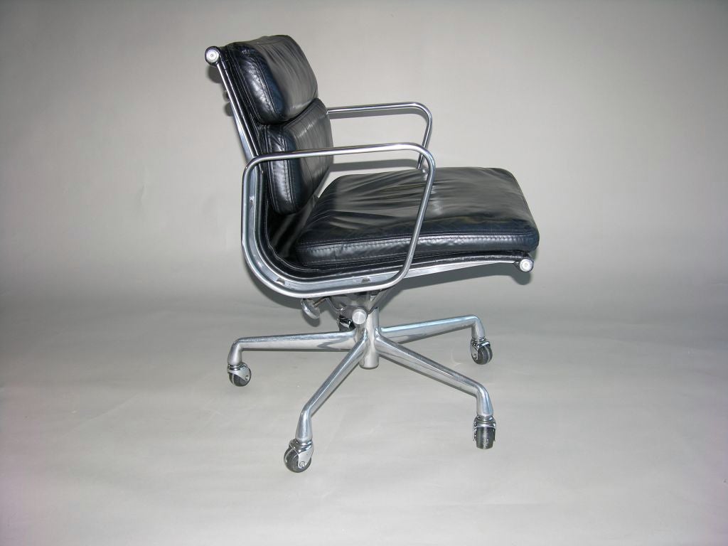 Charles Eames Soft pad chair EA217 , genuine Herman Miller production , black leather with aluminium arms and steel base , height adjustable , tilt and swivel mechanisms . Signed with molded manufacturer's mark to underside of each example. Large