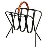 Black painted metal magazine rack with tan leather handle