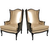 Pair of large ebonised wing chairs