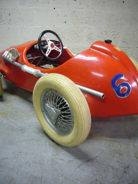 Child peddle car in the style of Ferrari.