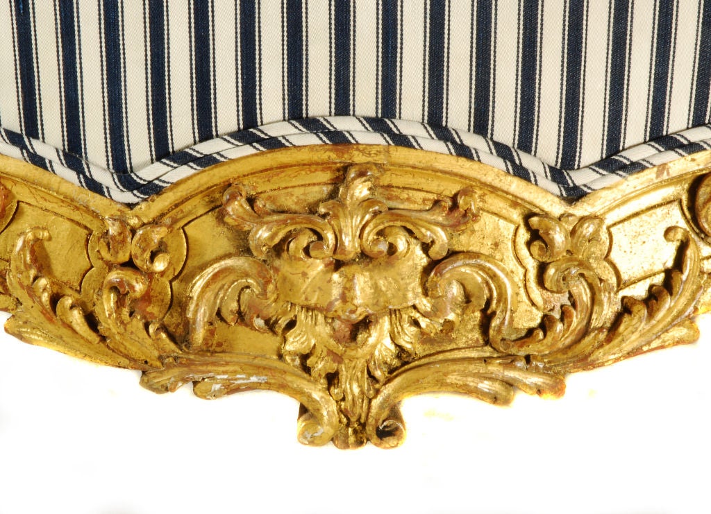 19th Century Pair highly carved Louis XV/Régence style wingback armchairs.