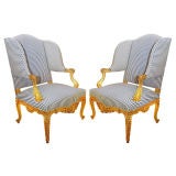 Pair highly carved Louis XV/Régence style wingback armchairs.