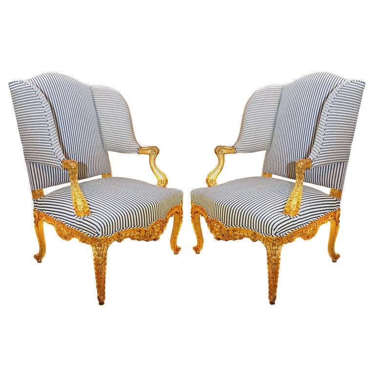 Pair highly carved Louis XV/Régence style wingback armchairs.