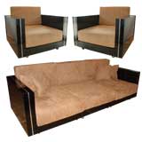 A black lacquer and chrome sofa with two armchairs