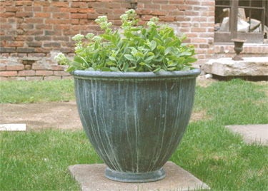 Early 20th century style lead urn; the original was designed by Walter Gilbert, the English founder of the Guild of Applied Arts. Priced individually.